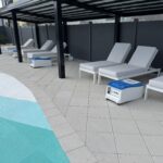 Resort pool area featuring LounGenie-equipped cabanas