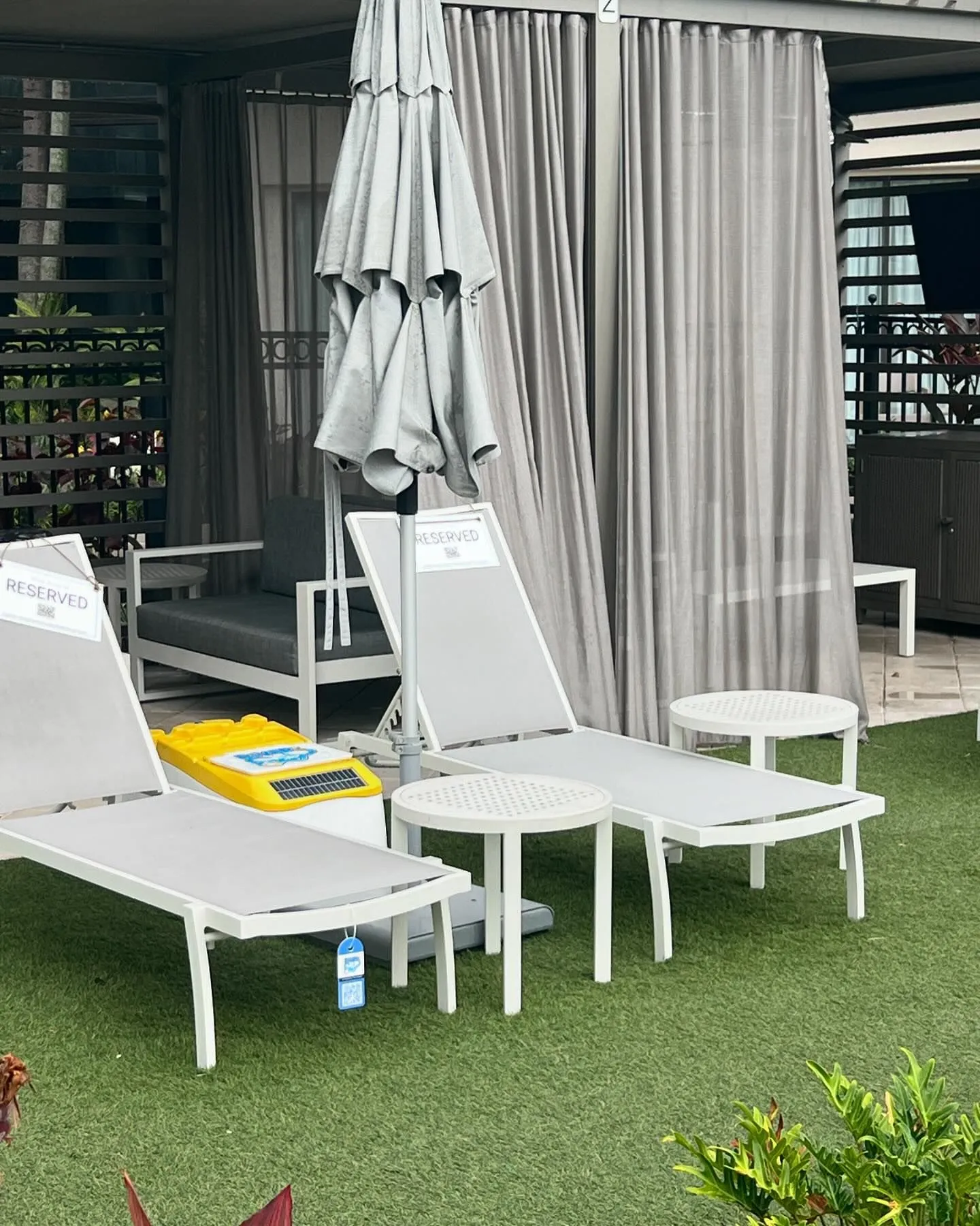 LounGenie CHARGE solar USB device charging at cabana