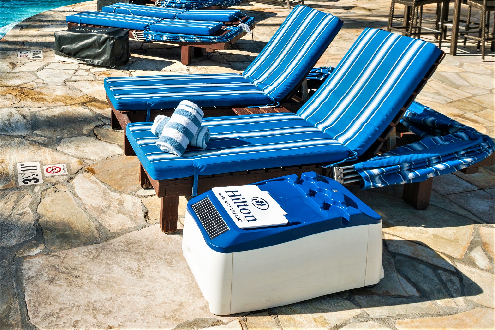 Close-up of LounGenie waterproof safe and USB charging in resort cabana